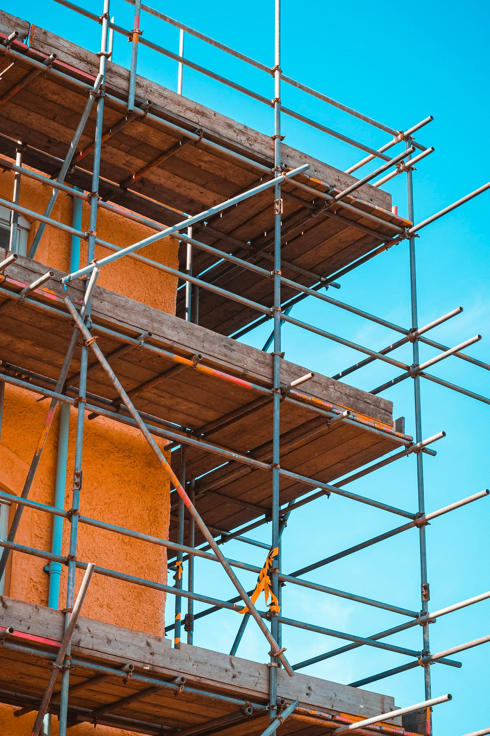 Access scaffolding erected on a building facade for painting and finishing work in Dubai